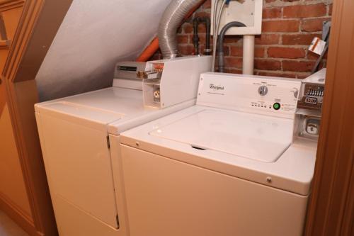 a washer and dryer sitting on top of a refrigerator at Furnished Studio in the South End #4 in Boston