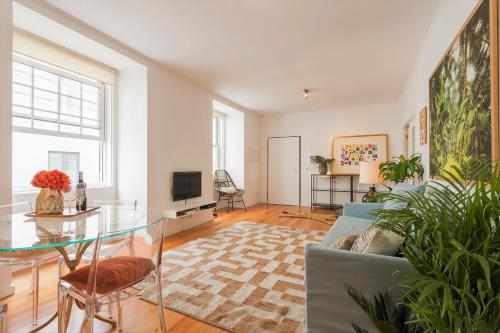 a living room with a couch and a glass table at Downtown - Chiado & Me in Lisbon