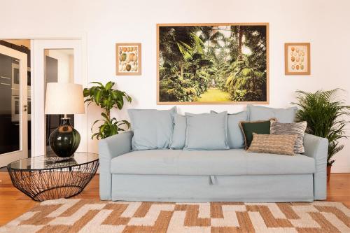 a living room with a couch and a painting on the wall at Downtown - Chiado & Me in Lisbon