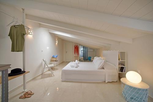 a white bedroom with a large white bed in a room at Giorgos & Maria Villas in Ágios Matthaíos