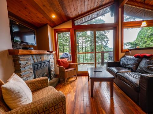 a living room with a couch and a fireplace at The Cabins at Terrace Beach in Ucluelet