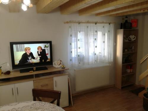 a living room with a tv and a window at Kuća za odmor "Jasna" (Holiday home "Jasna") in Crni Lug