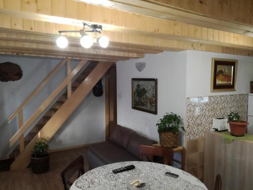 a dining room with a table and a staircase at Kuća za odmor "Jasna" (Holiday home "Jasna") in Crni Lug