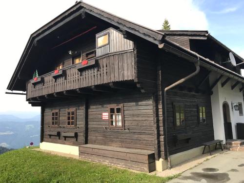 a wooden house on top of a hill at One-Of-A-Kind NASSFELD APARTMENTS in Sonnenalpe Nassfeld