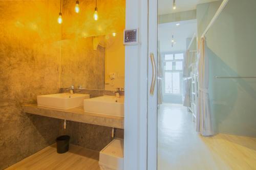 a bathroom with two sinks and a mirror at Ekanake hostel in Bangkok
