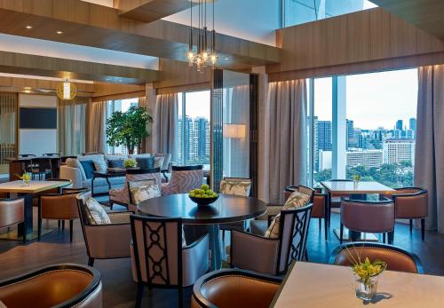 a restaurant with tables and chairs and a view of the city at Shangri-La Singapore in Singapore