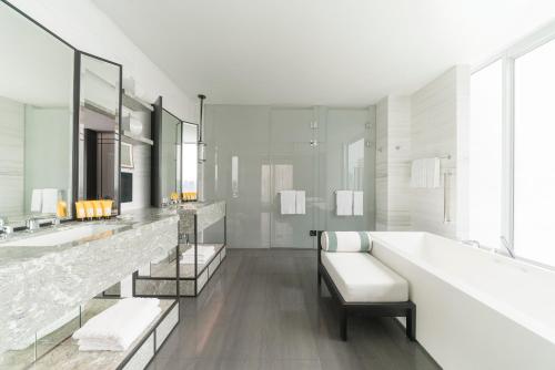 a bathroom with two sinks and two mirrors at Shangri-La Singapore in Singapore