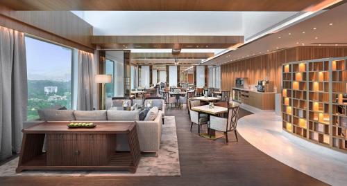 a hotel lobby with a couch and tables and chairs at Shangri-La Singapore in Singapore