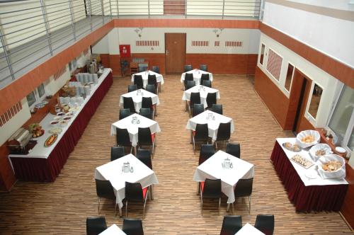 an overhead view of a dining room with tables and chairs at Atlantic Hotel in Budapest
