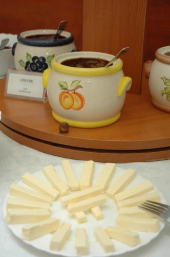 a plate with a cup of coffee and a plate of food at Atlantic Hotel in Budapest