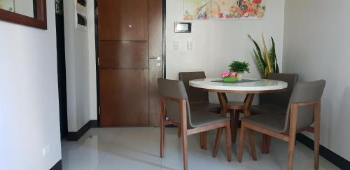 a dining room with a table and chairs in a room at Mactan Newtown Ocean View 360 Degree in Mactan