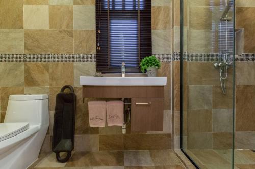 a bathroom with a sink and a toilet and a shower at Baan Lily in Chaweng