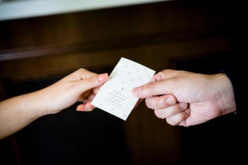 two hands holding up a piece of paper at H Boutique Hotel Sri Petaling in Kuala Lumpur