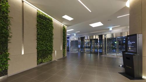 a hallway with a green wall in a building at Nine Tree by Parnas Seoul Myeongdong 2 in Seoul