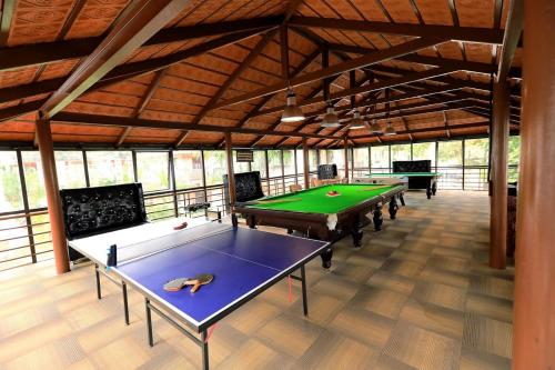 a row of ping pong tables in a large room at Jal Mahal Resort and Spa in Mysore
