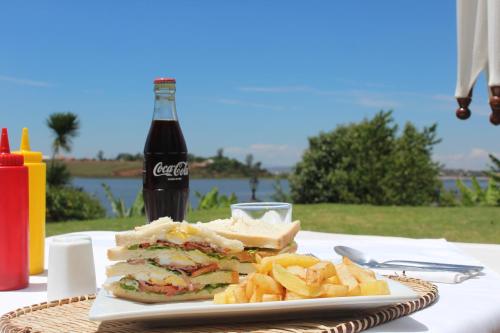 a sandwich and chips on a plate with a soda at Riviera Garden in Antananarivo
