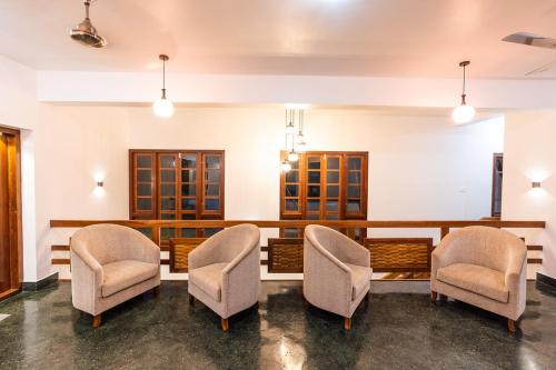 a waiting room with chairs and a table at The Ayur Villa in Kovalam