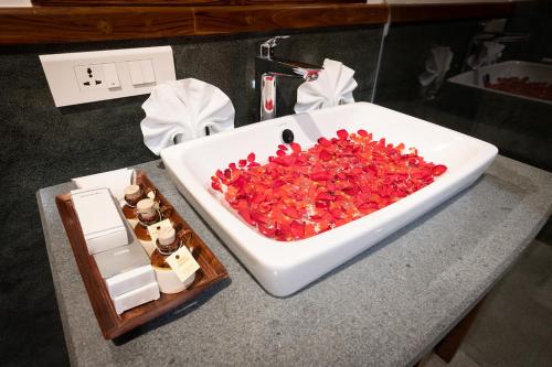 a bath tub filled with red peppers on top of a counter at The Ayur Villa in Kovalam