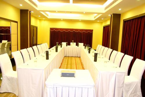a meeting room with white tables and white chairs at Gokulam Park Sabari-Siruseri SIPCOT in Chennai