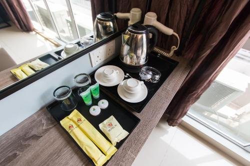 a tray of food on a counter in a room at Hotel 99 Bandar Puteri Puchong in Puchong