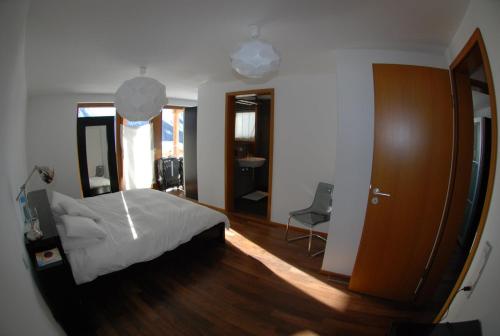 1 dormitorio con cama y espejo grande en Ayoba en Wiler