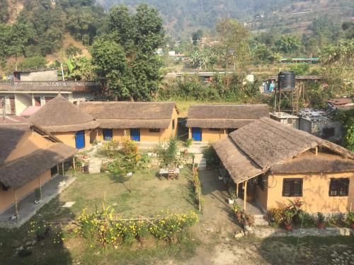 an aerial view of a village with houses with thatched roofs at My beautiful cottage in pokhara in Pokhara