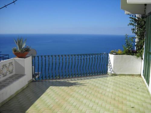a balcony with a blue fence and the ocean at Le Cicale - Apartments in Conca dei Marini