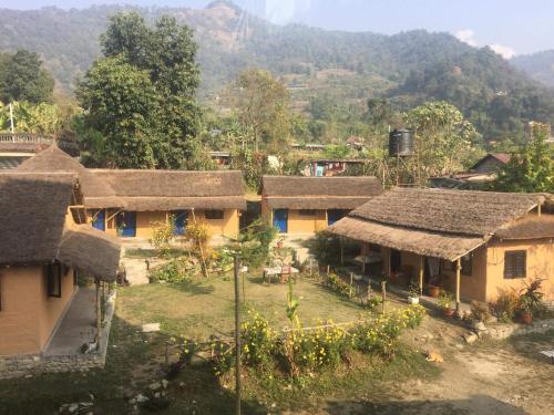 a group of houses with mountains in the background at My beautiful cottage in pokhara in Pokhara