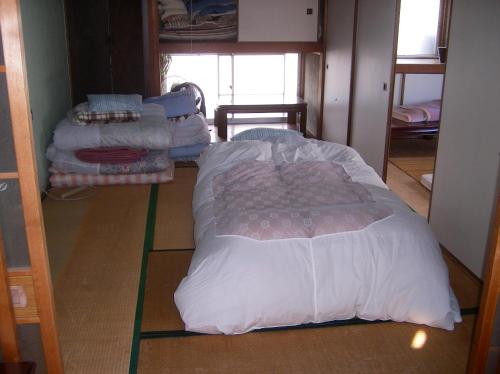 a room with several beds sitting on the floor at House of the Rising Sun in Takatuki