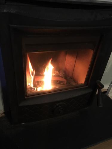 a fireplace with a fire inside of it at Hopetoun Haven in Gullane