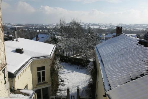 a snow covered roof of a house with snow covered roofs at Aux Herbes Folles in Herve
