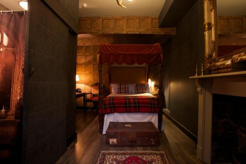 a bedroom with a bed with a red canopy at Georgian House Hotel in London