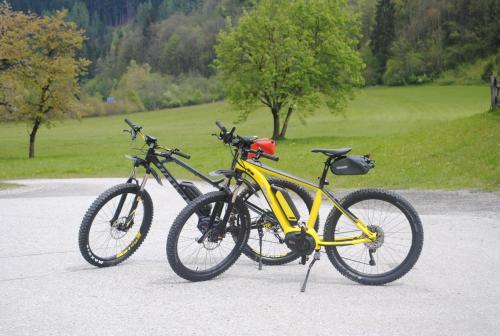 two bikes parked next to each other on a road at Familien-Bauernhof Neumoar in Sankt Johann im Pongau