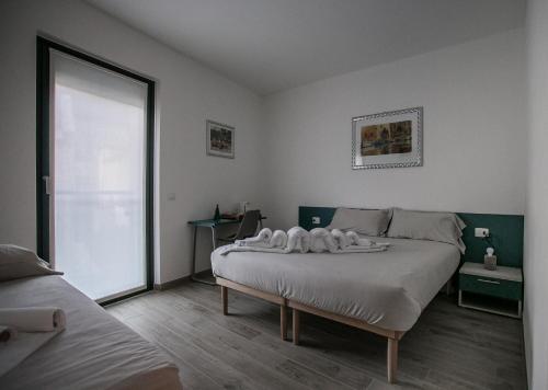 a bedroom with a large bed and a large window at B & B Il sorriso in Tirano