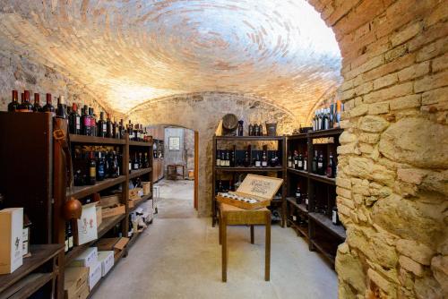bodega con techo abovedado y estanterías de botellas de vino en Bes Hotel Papa San Pellegrino Terme en San Pellegrino Terme
