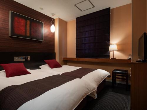 Ένα ή περισσότερα κρεβάτια σε δωμάτιο στο Fujieda Park Inn Hotel