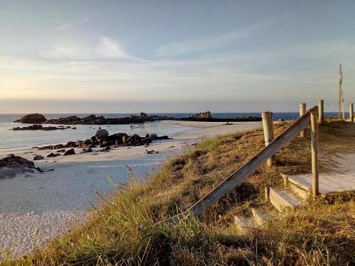 a fence on a beach near the water at L'écurie Kerdoel in Cléder