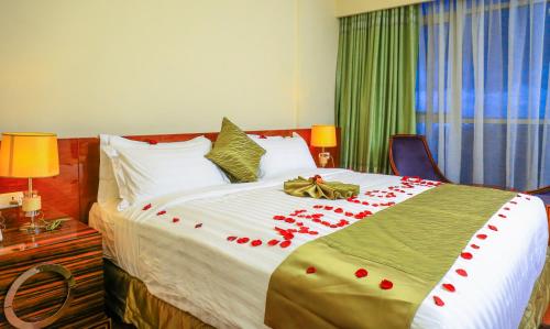 a bedroom with a bed with red roses on it at Denver boutique hotel in Addis Ababa