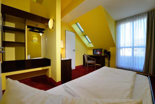 Säng eller sängar i ett rum på INVITE Hotel Nürnberg City