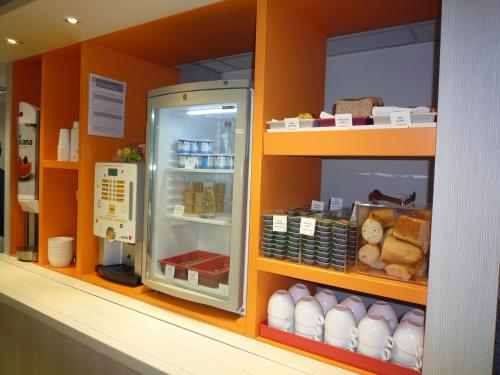 a refrigerator in a store with eggs and bread at Première Classe Valence Sud in Valence