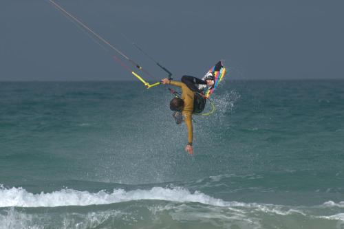 a man is doing a trick in the ocean at L'écurie Kerdoel in Cléder