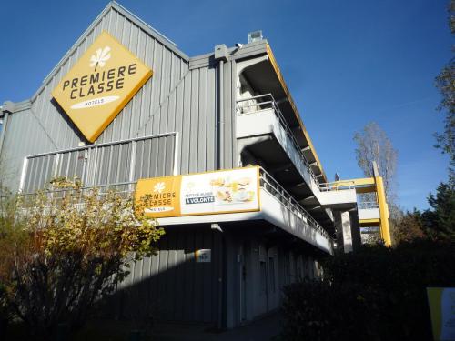 a building with a sign on the side of it at Première Classe Valence Sud in Valence