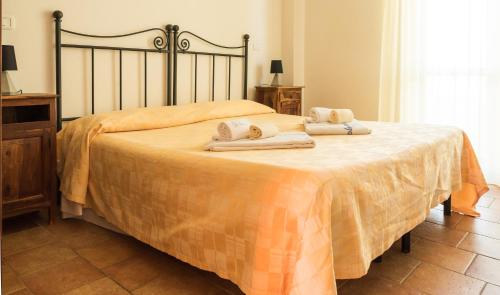 a hotel room with a bed and a dresser at Villaggio Le Querce in Sorano