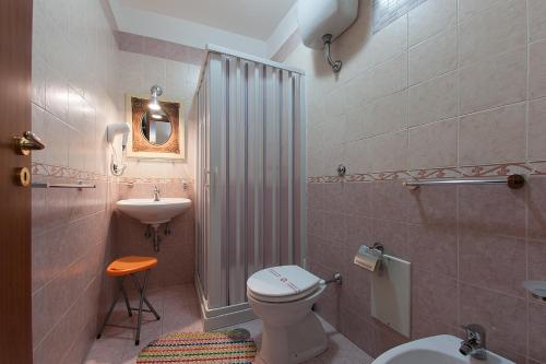 a bathroom with a toilet and a sink at Anna's Family in Naples