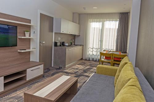 a living room with a couch and a kitchen at Plaza35 in Sibiu