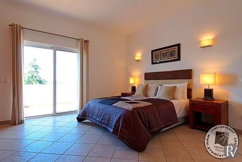 
A bed or beds in a room at Alvor Villa Sleeps 8 Pool Air Con WiFi
