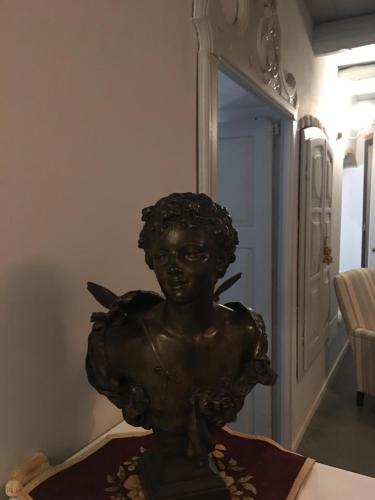 a bronze statue of a girl sitting on a table at ANTICA VILLA CUNEO- Guest House - "B&B e non un Hotel a Cuneo" in Cuneo