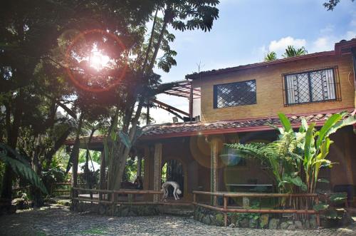 a house with a dog standing in front of it at The Secret Buddha in Medellín