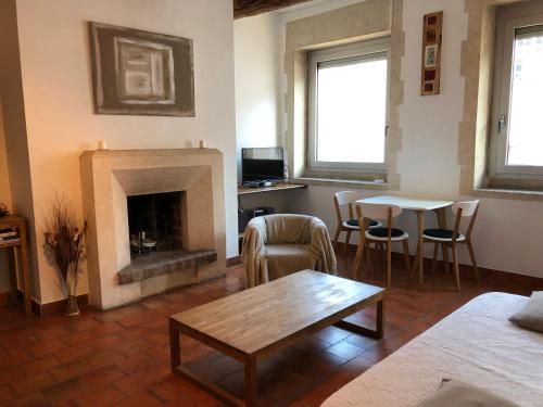 a living room with a fireplace and a table and chairs at Escapade Vieux-Port in Marseille