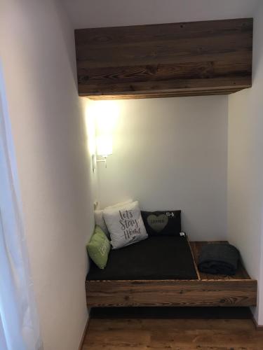 a room with a bench with pillows on it at Ramseiderhof in Saalfelden am Steinernen Meer